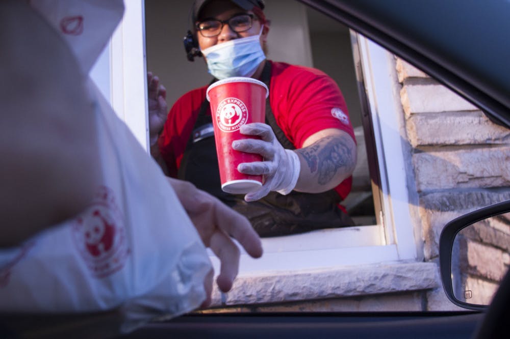 Kya Johnson, 19, passes food to a drive-thru customer.&nbsp;&nbsp;
