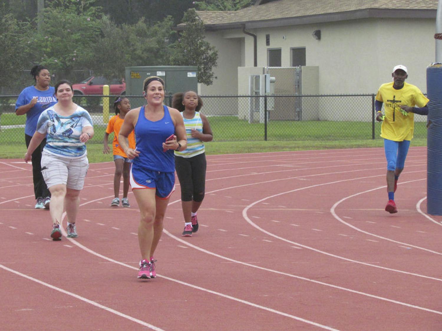Kourtney Oliver (center), the program coordinator for the Healthiest Weight Florida initiative in Alachua County, runs in the inaugural World Heart Day 5K event at Fred Cone Park on Sept. 26, 2015. Forty-seven people registered to run to raise awareness for heart disease and stroke prevention.