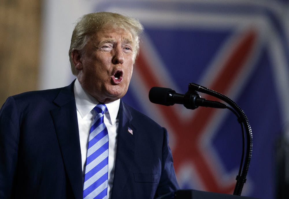 President Donald Trump speaks at Fort Drum, N.Y., Monday, Aug. 13, 2018, before a signing ceremony for a $716 billion defense policy bill named for Sen. John McCain. (AP Photo/Carolyn Kaster)