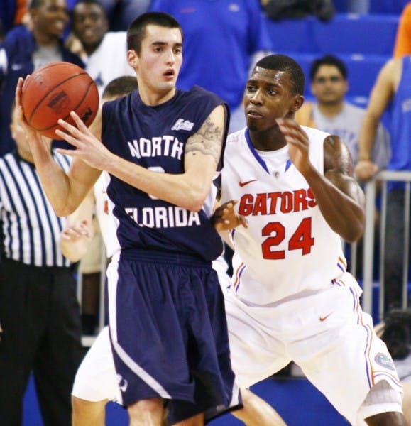 Florida forward Casey Prather (24) defends North Florida guard Parker Smith on Nov. 17, 2011, in the O’Connell Center. After missing the first five games of 2012-13 due to multiple concussions suffered in the preseason, Prather cut his lip in his return to the court.&nbsp;