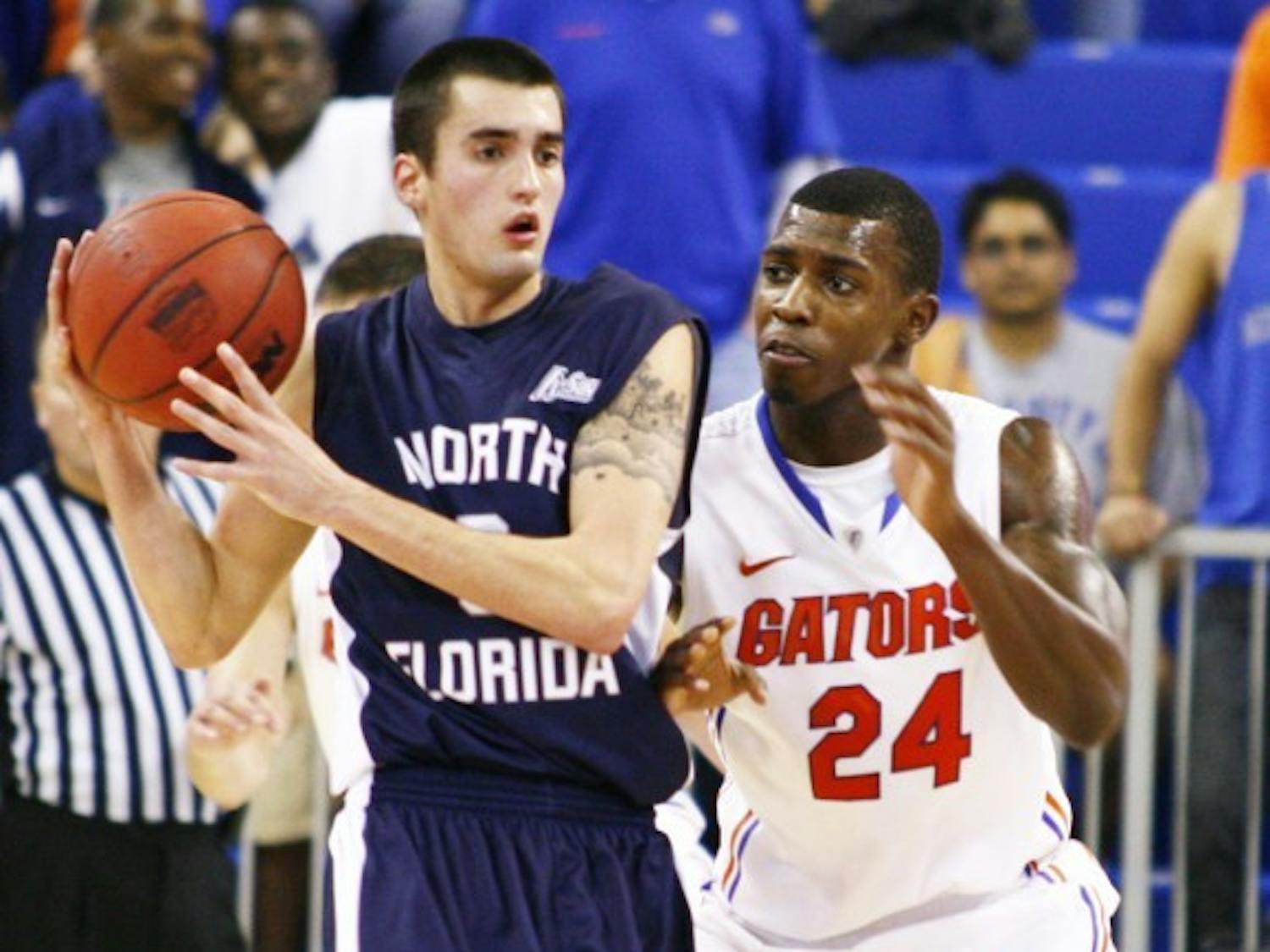 Florida forward Casey Prather (24) defends North Florida guard Parker Smith on Nov. 17, 2011, in the O’Connell Center. After missing the first five games of 2012-13 due to multiple concussions suffered in the preseason, Prather cut his lip in his return to the court. 