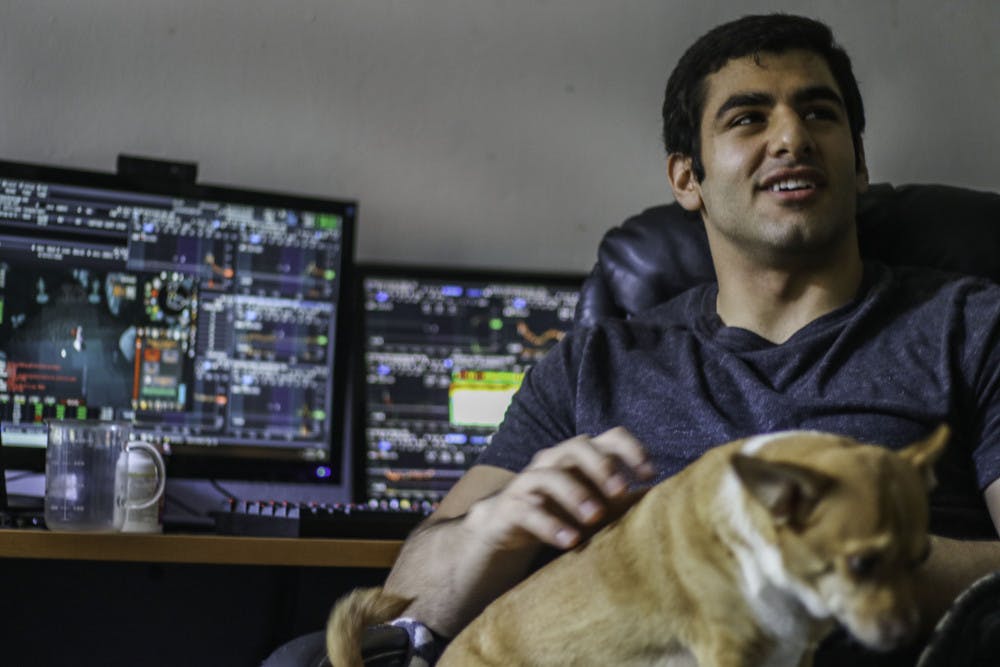 Jamal Waked, a 23-year-old UF alumnus, holds his dog Sonny Thursday while being interviewed in his apartment at College Park, 303 NW 17th St. Waked made living alone a priority when he was looking for an apartment. “I need my own space. I need to do my own thing,” he said.