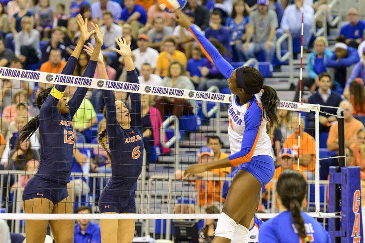 Redshirt senior middle blocker Chloe Mann spikes the ball over the net in Florida’s 3-0 win against Auburn on Oct. 25 in the O’Connell Center.