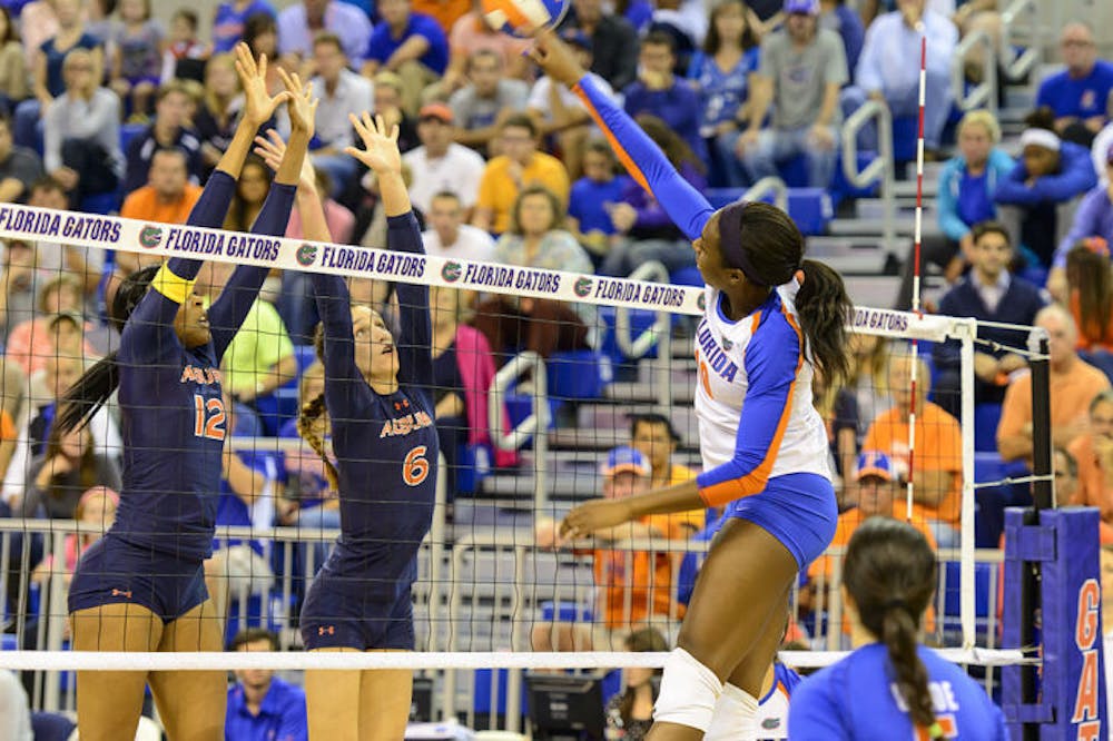 <p>Redshirt senior middle blocker Chloe Mann spikes the ball over the net in Florida’s 3-0 win against Auburn on Oct. 25 in the O’Connell Center.</p>