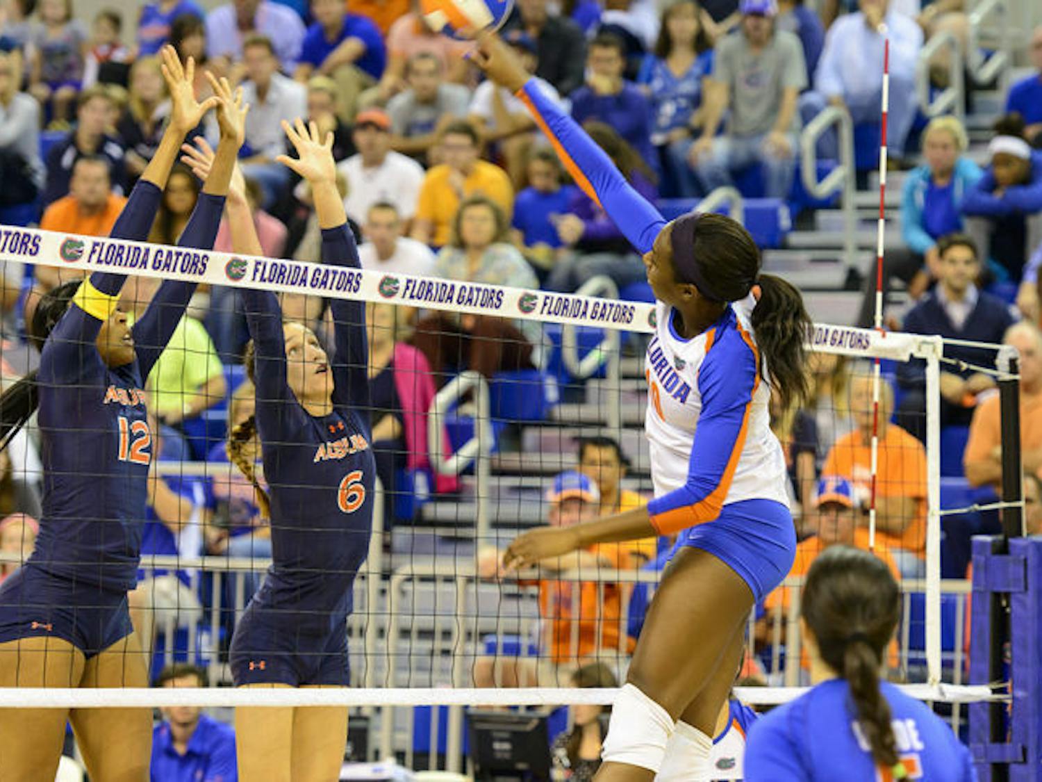 Redshirt senior middle blocker Chloe Mann spikes the ball over the net in Florida’s 3-0 win against Auburn on Oct. 25 in the O’Connell Center.