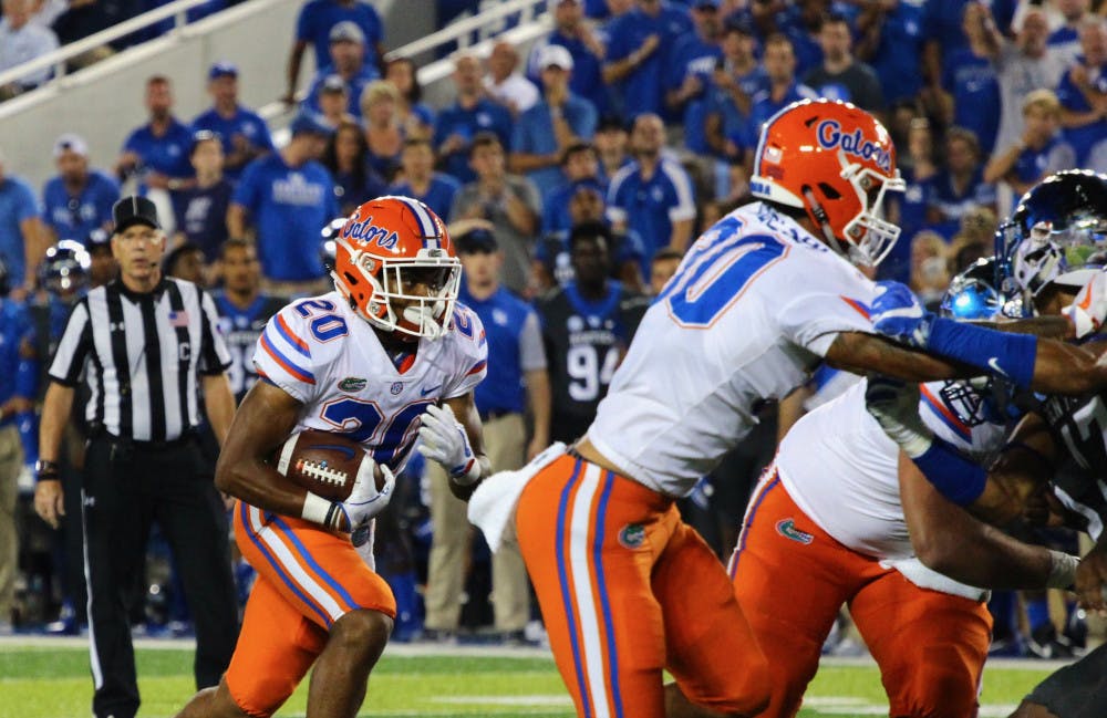 Malik Davis carries the ball during Florida's 28-27 win against Kentucky on Saturday night at Kroger Field.