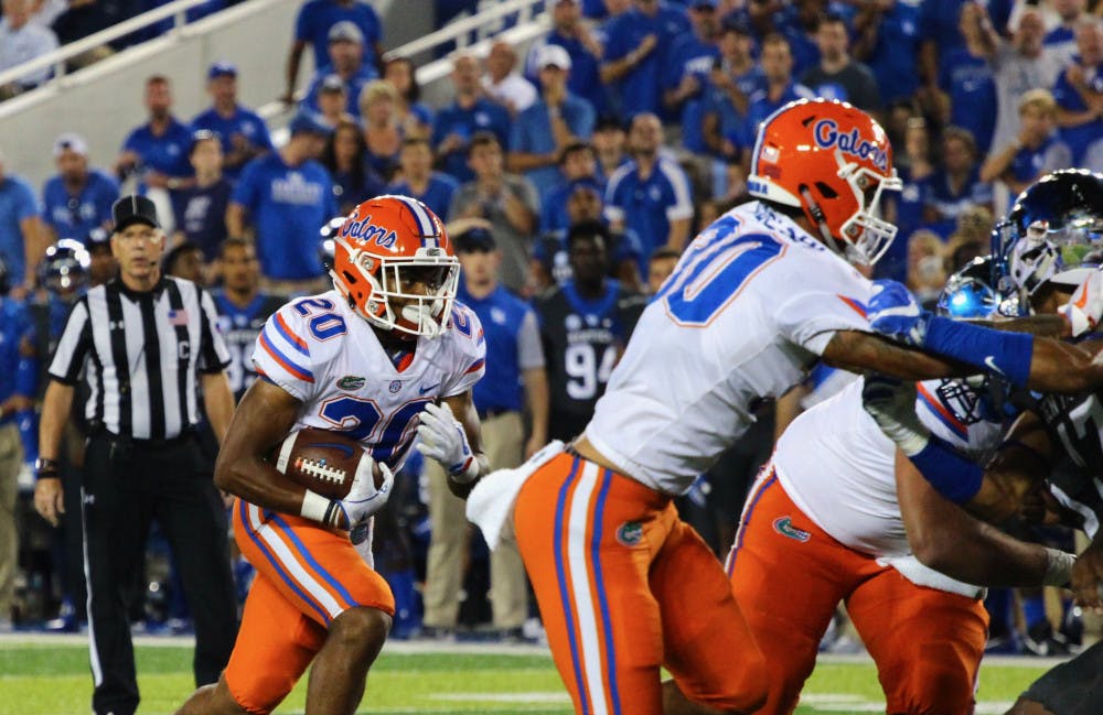 <p>Malik Davis carries the ball during Florida's 28-27 win against Kentucky on Saturday night at Kroger Field.</p>