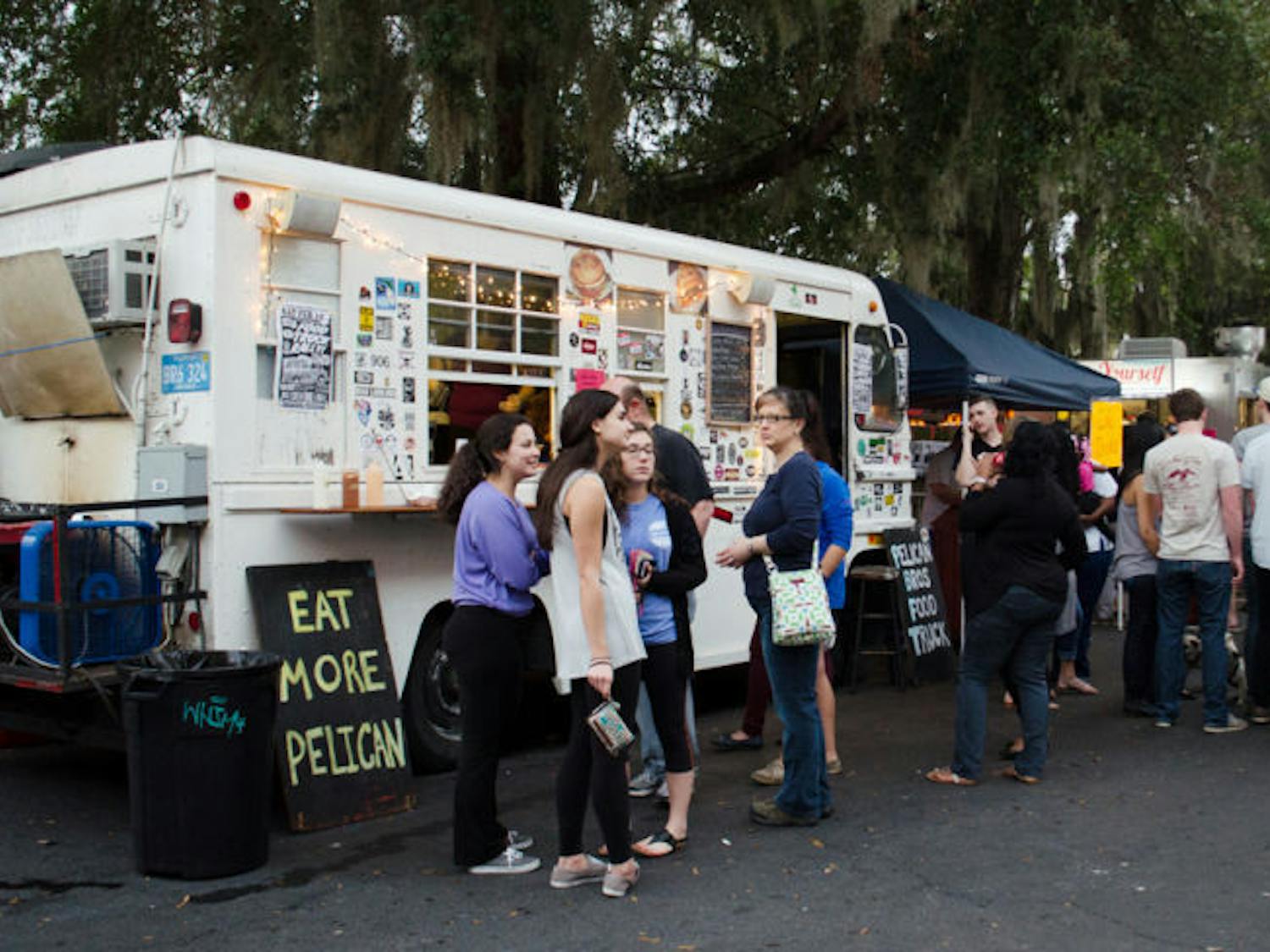 Customers wait for their orders in front of the Pelican Brothers food truck at the Original Gainesville Food Truck Rally on Saturday, hosted near High Dive. The rally drew 11 food trucks from across the state. 