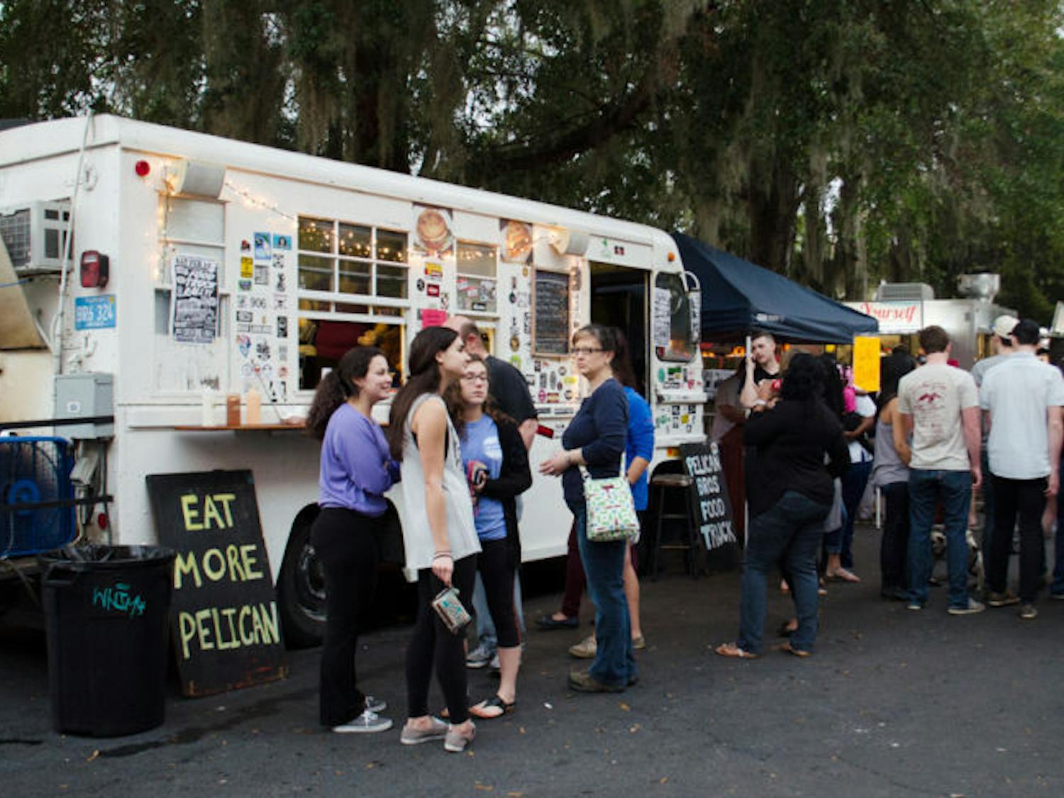 Customers wait for their orders in front of the Pelican Brothers food truck at the Original Gainesville Food Truck Rally on Saturday, hosted near High Dive. The rally drew 11 food trucks from across the state. &nbsp;
