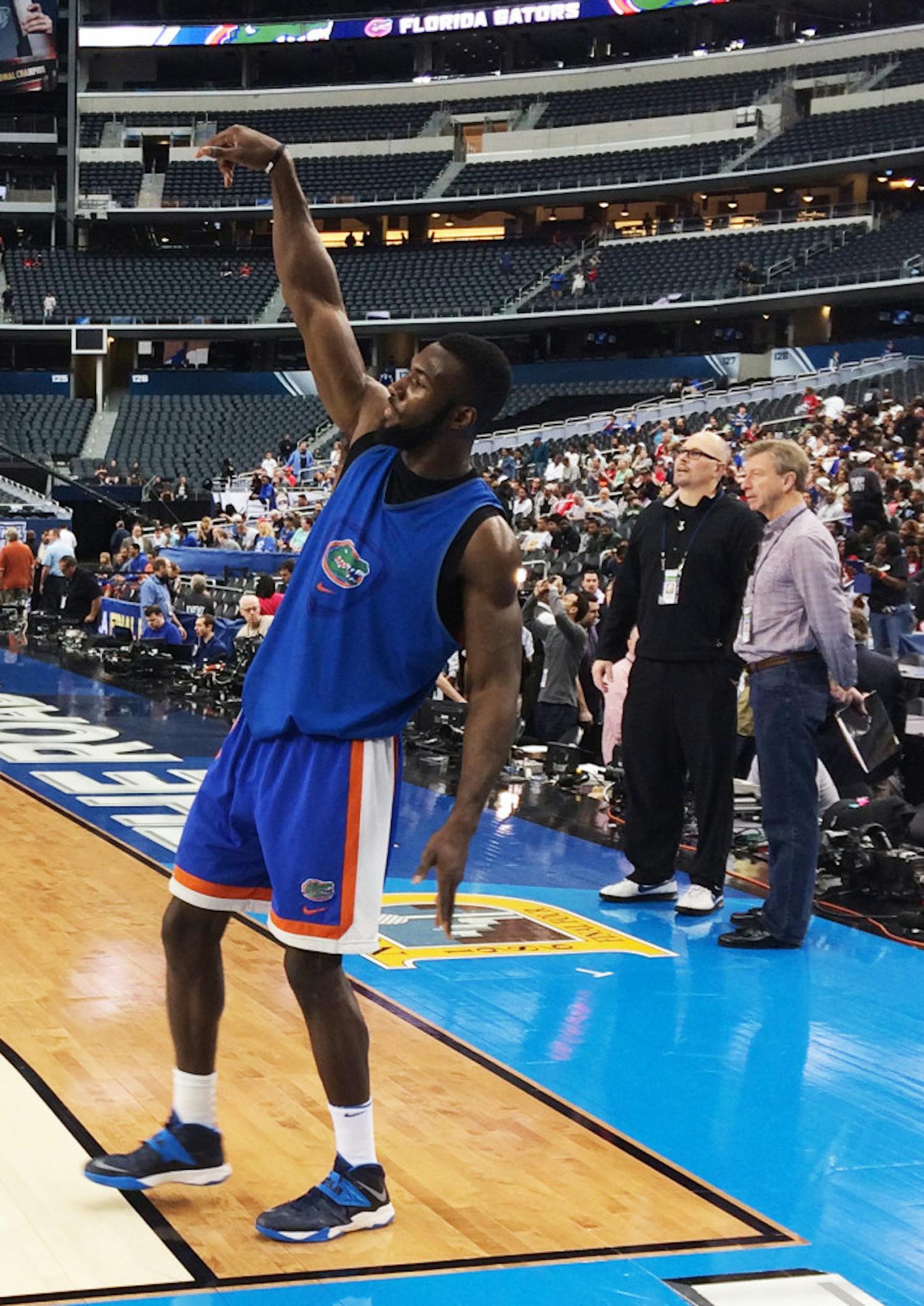 Senior center Patric Young holds his release after attempting a rare three-pointer during the Gators' open practice Friday afternoon in AT&amp;T Stadium in Arlington, Texas.