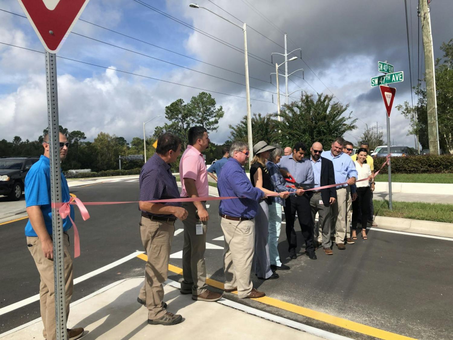 


City Commissioner David Arreola cuts the ribbon for the grand opening of the new road linking SW 47th Avenue and 40th Boulevard to Archer Road Tuesday at 10:30 a.m.. This road was built to give drivers a more direct route through the city as well as pull traffic off Archer Road, 34th Street and I-75.&nbsp;


