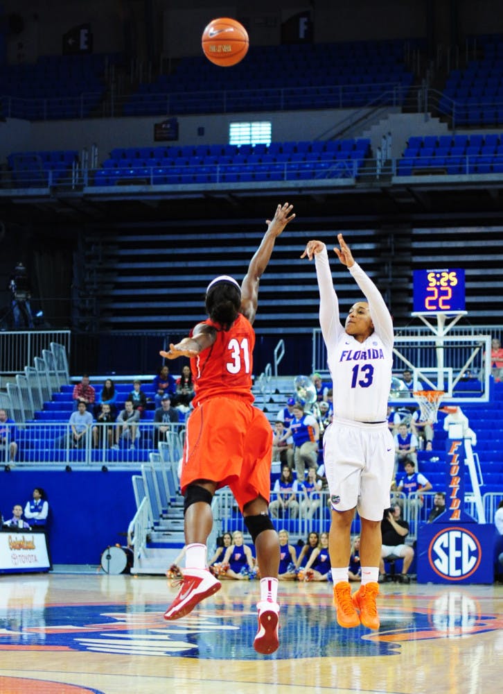 Cassie Peoples attempts a three-point shot against Georgia on Sunday in the O’Connell Center. UGA outscored UF by 12 in the second half.