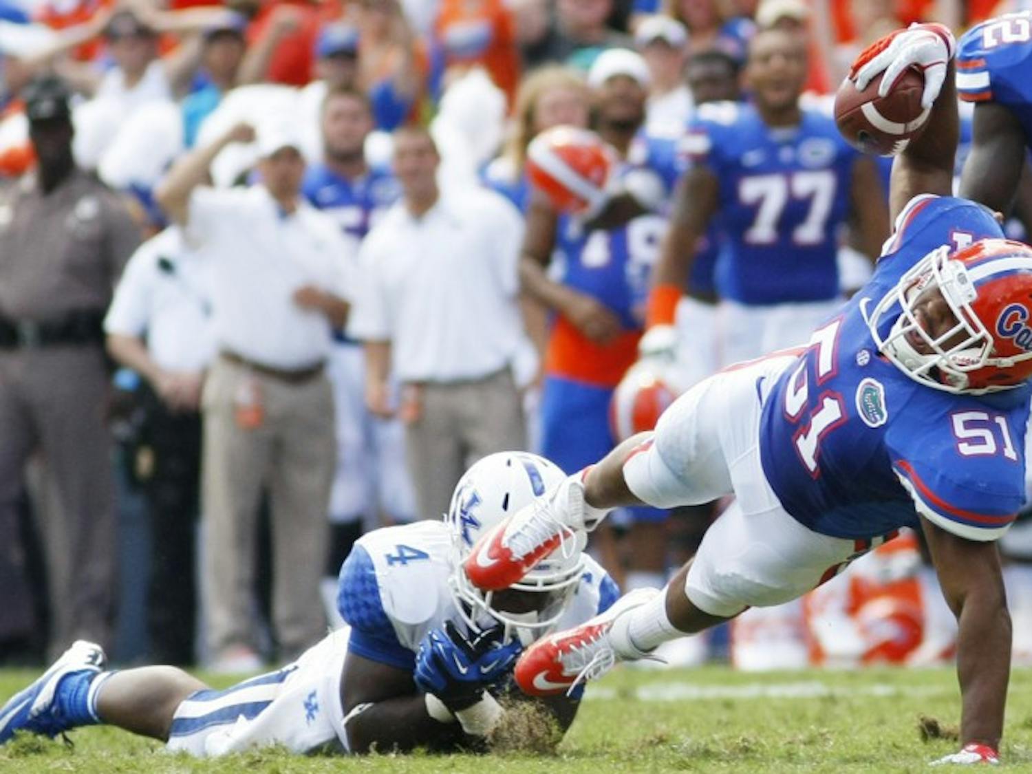 Sophomore linebacker Michael Taylor goes to the ground after intercepting a pass thrown by Morgan Newton against Kentucky at Ben Hill Griffin Stadium on Saturday. Florida extended its winning streak against the Wildcats to 26 games.