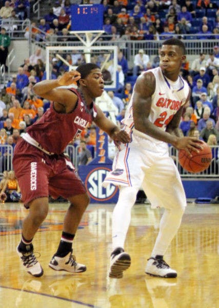 UF’s Casey Prather looks to pass the ball during the Gators’ 74-56 win against South Carolina in the season’s SEC opener on Wednesday night. Prather is questionable for Florida’s road game against Arkansas on Saturday due to swelling in his right knee.