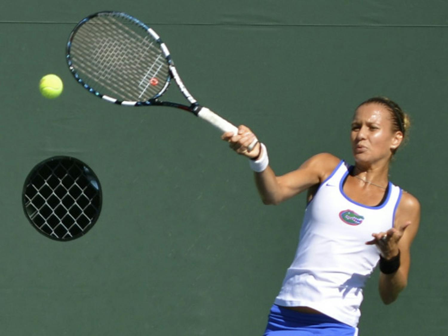 Senior Olivia Janowicz swings at the ball during her second-round singles match against FSU freshman Eduarda Dos Santos on Oct. 11, 2013, at the Bedford Cup at the Ring Tennis Complex.
