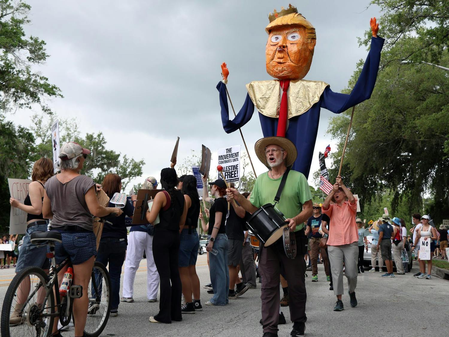 Protestors march with a paper-machete puppet of President Trump down Southwest Sixth Street during the "No Kings Day" protest on Saturday, June 14, 2025.