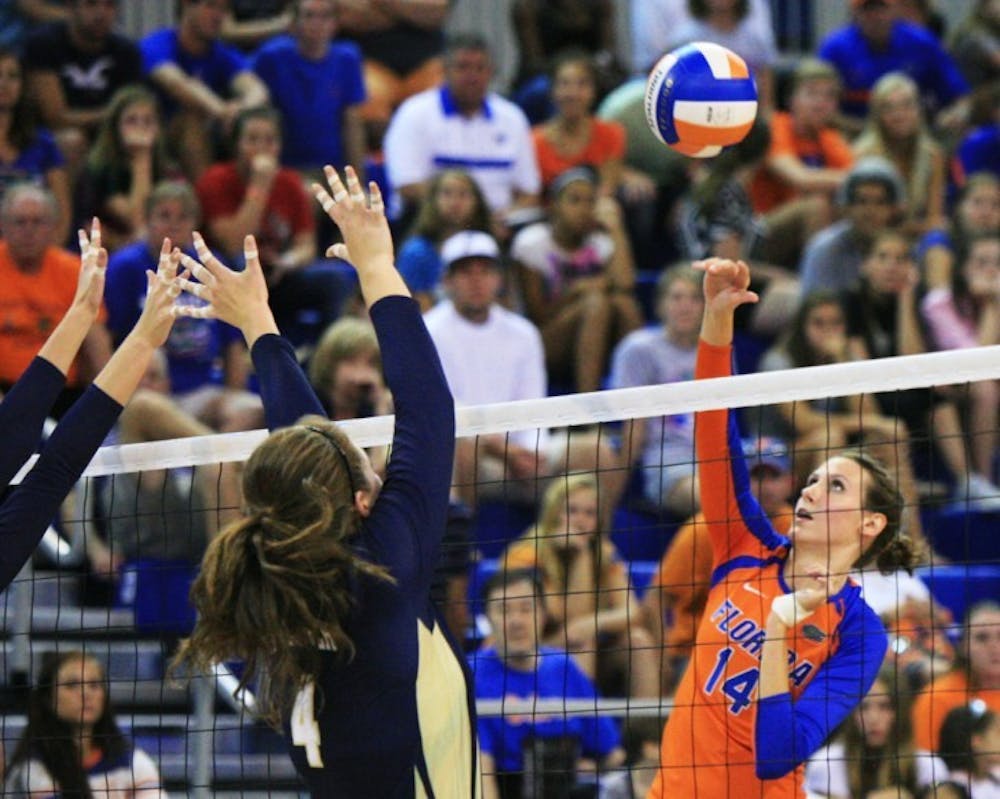 <p>Middle blocker Betsy Smith (14) spikes the ball against Georgia Tech in a 3-1 victory on Sept. 8. The senior led the Gators with a season-high 11 blocks in Florida's sweep of Arkansas on Friday night.</p>