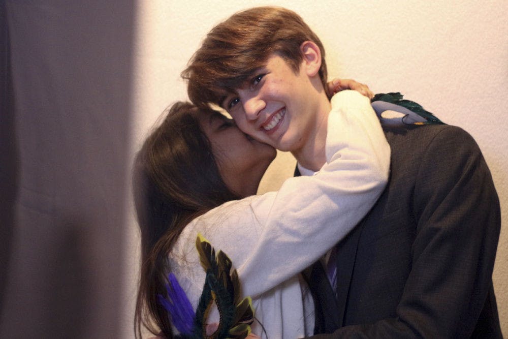 Nafisa Choudhury, an 18-year-old biochemistry sophomore, grabs Steven Remington, a 19-year-old computer science sophomore, to kiss him in front of a SNAP! photo booth at the Queer Prom, put on for Pride Awareness Month on Thursday night in the Graham Hall gallery. Choudhury came with her LGBTQ+-identifying friend to meet new people.