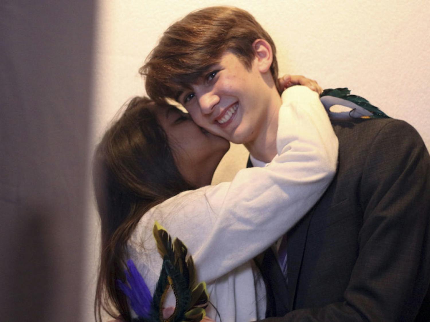 Nafisa Choudhury, an 18-year-old biochemistry sophomore, grabs Steven Remington, a 19-year-old computer science sophomore, to kiss him in front of a SNAP! photo booth at the Queer Prom, put on for Pride Awareness Month on Thursday night in the Graham Hall gallery. Choudhury came with her LGBTQ+-identifying friend to meet new people.