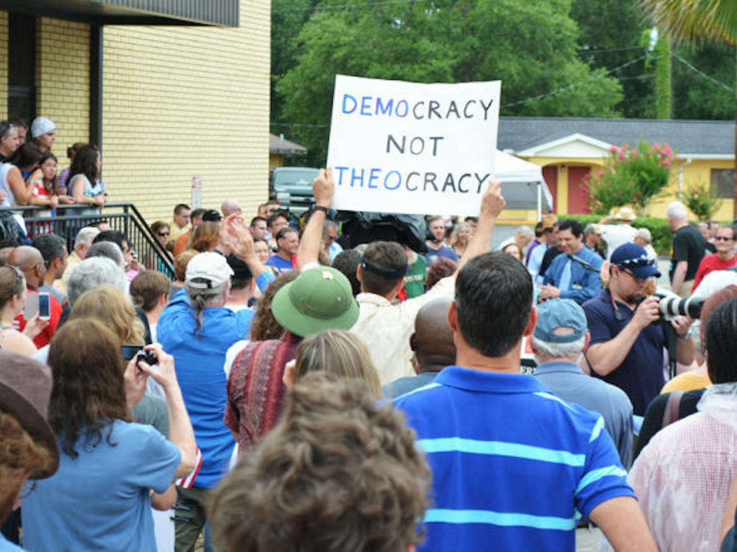 Crowds gather in front of the Bradford County Courthouse on Saturday, June 29, for the unveiling of an atheist monument near a monument of the Ten Commandments in Starke, Fla.