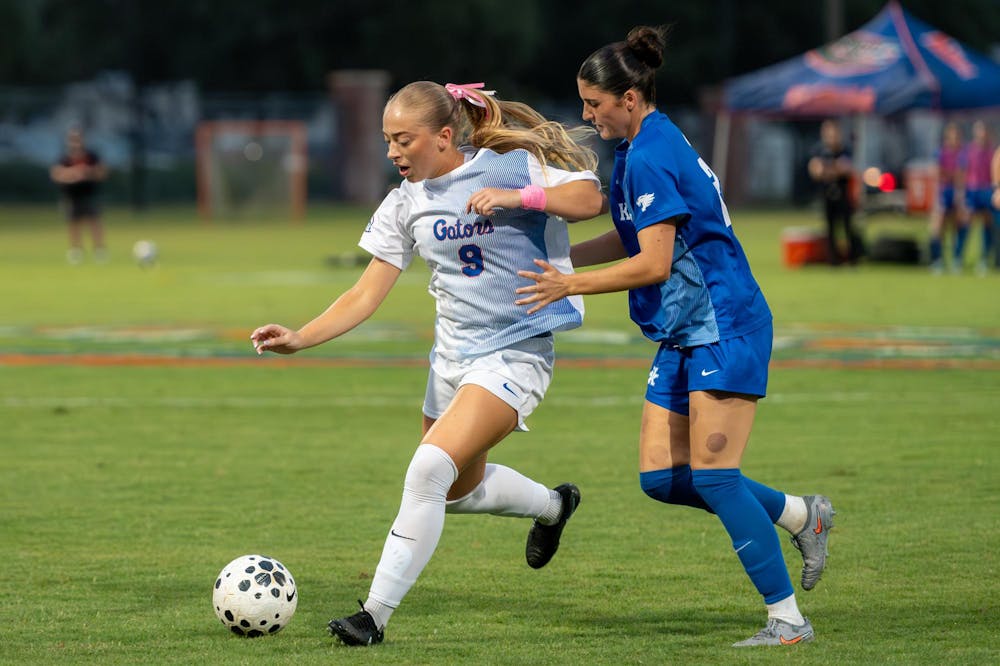 Florida Gators forward Addy Hess (9)  fights a defender for the ball in a match against the Kentucky Wildcats on Oct. 2, 2025, at Donald Disney Stadium in Gainesville, Fla. The Gators tied the Wildcats 1-1.