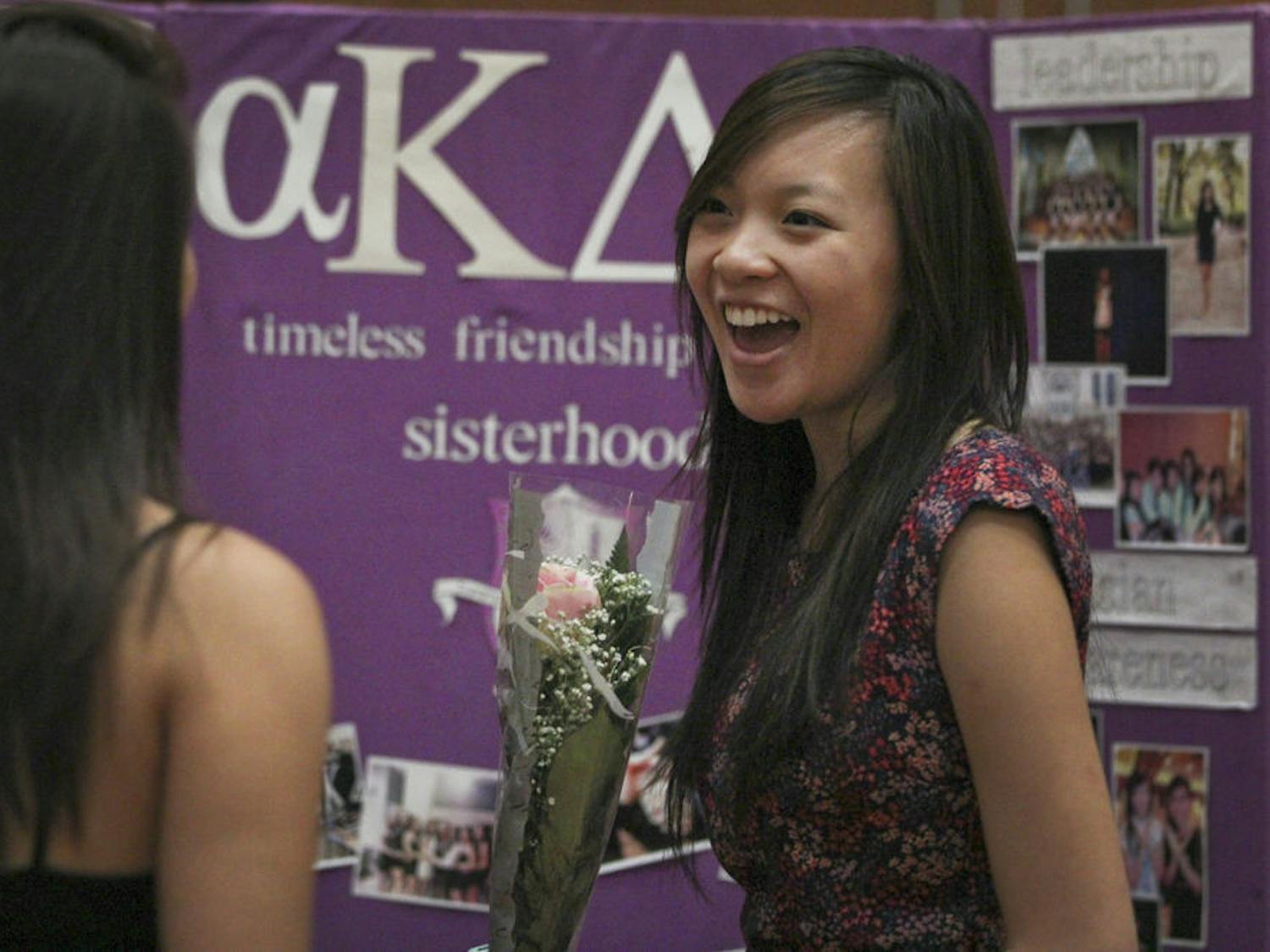 Nikki Nguyen, a 21-year-old UF sociology junior and Alpha Kappa Delta Phi sister, laughs with a friend while representing her sorority at the 2015 Asian Kaleidoscope Month opening ceremony Sept. 21, 2015. "Our sorority got a pink rose for one of our sisters for her first public performance," Nguyen said.