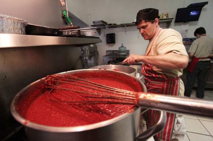 Joey Feulner, owner and cook at Bella Donna's Italian Eatery, cooks 30 quarts of marinara, or "red," sauce.