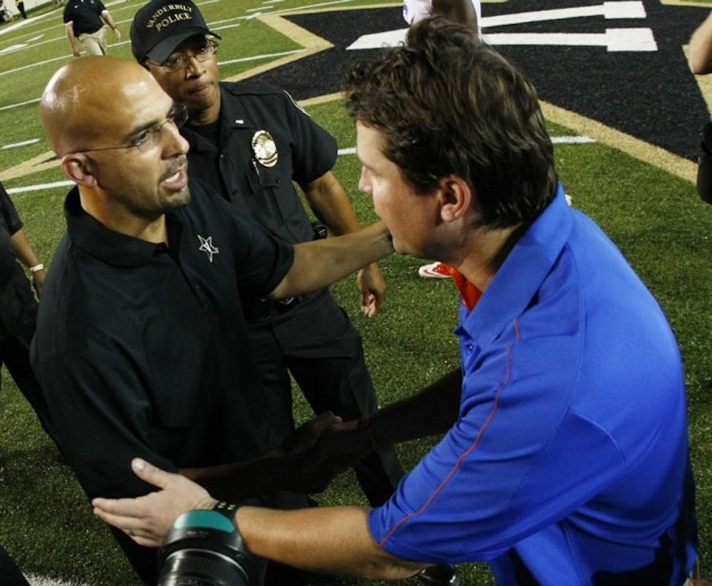 <p>Coach Will Muschamp (right) shakes hands with Vanderbilt coach James Franklin. If Franklin accepts the Penn State opening, Thomas Holley's choice in schools may sway in favor of Florida.</p>