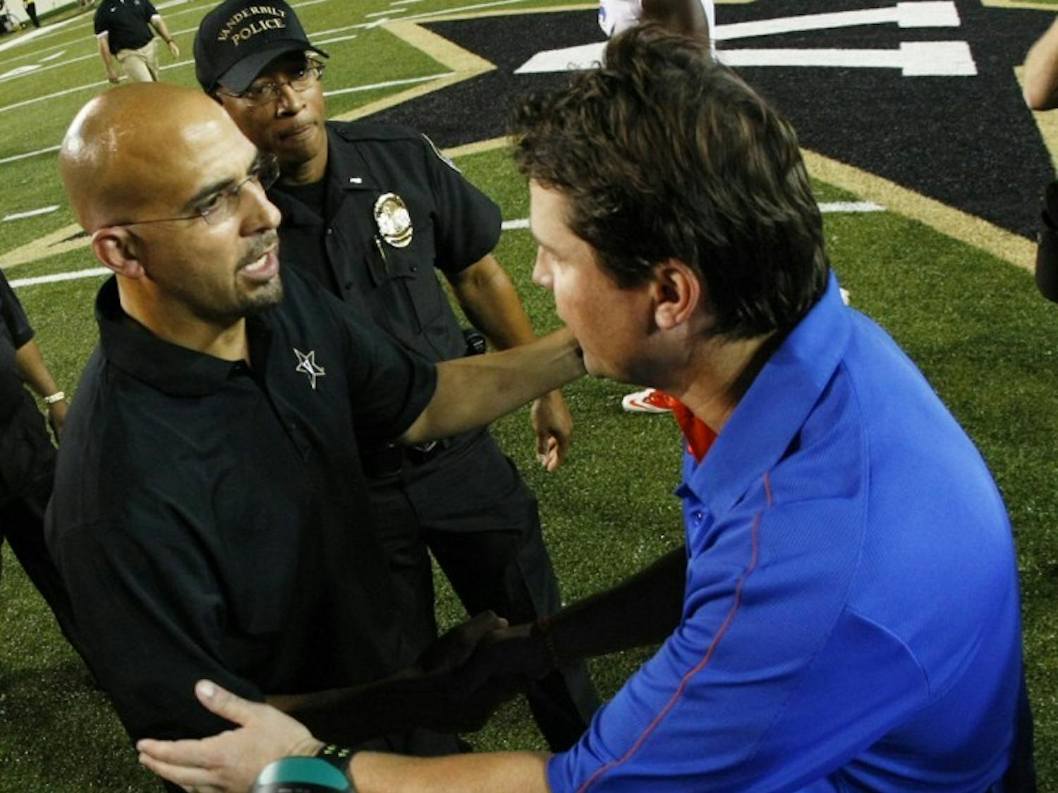 Coach Will Muschamp (right) shakes hands with Vanderbilt coach James Franklin. If Franklin accepts the Penn State opening, Thomas Holley's choice in schools may sway in favor of Florida.