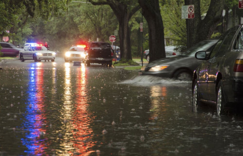 <p>A car pulls into floodwaters on Southwest First Avenue on Wednesday. The street was partially closed by police to prevent cars from stalling in deep water from Wednesday’s storms.&nbsp;</p>
<div>&nbsp;</div>