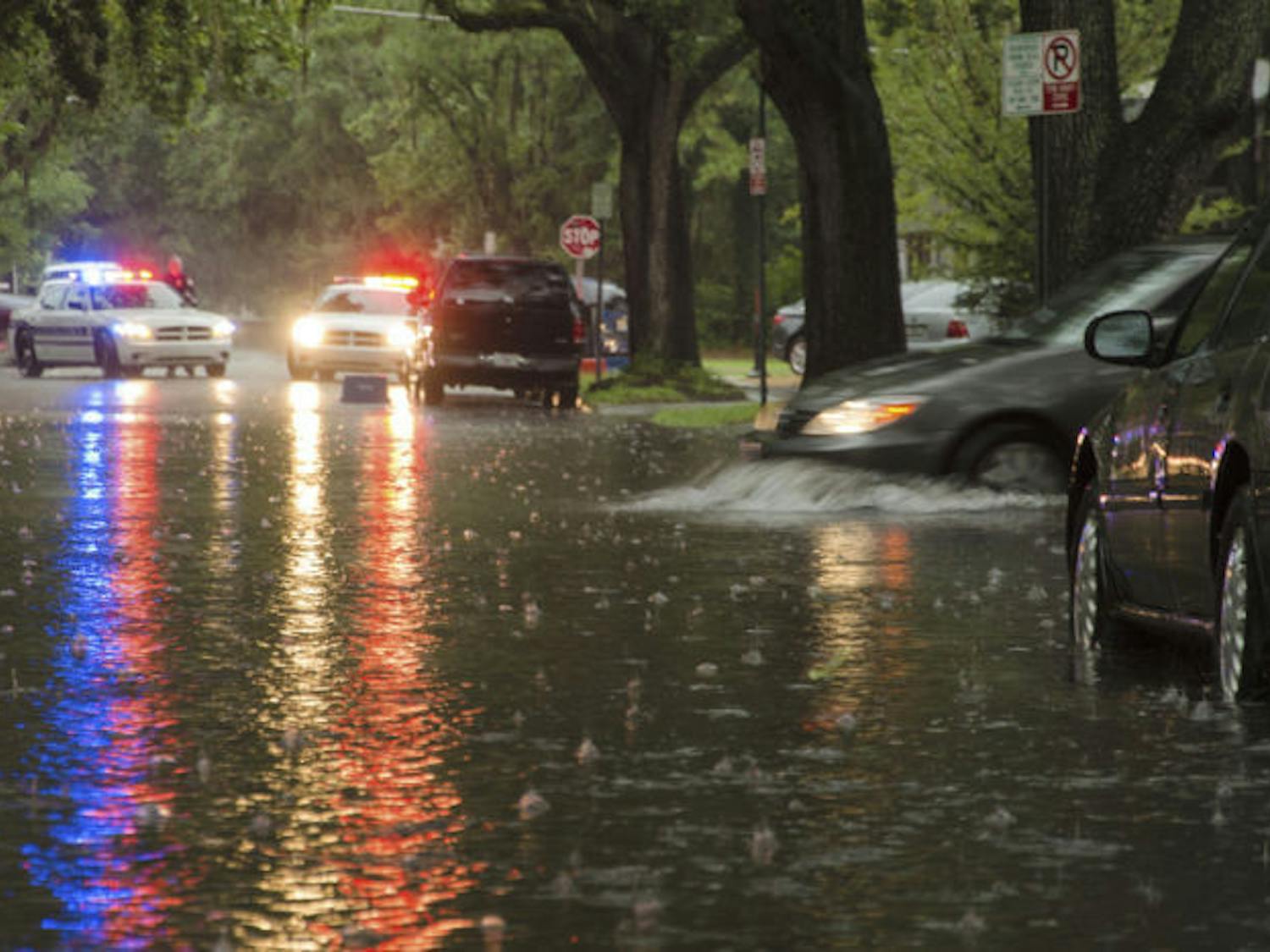 A car pulls into floodwaters on Southwest First Avenue on Wednesday. The street was partially closed by police to prevent cars from stalling in deep water from Wednesday’s storms.
