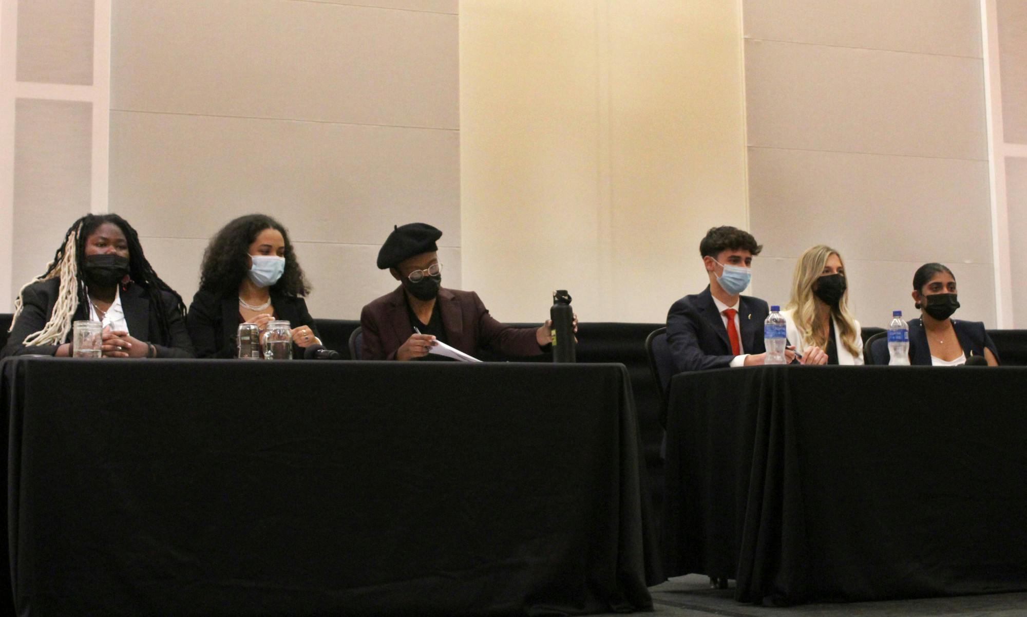 Student government executive ticket candidates for Change Party and Gator Party prepare for their opening speeches at the Reitz Union Rion Ballroom on Tuesday, Feb. 15.