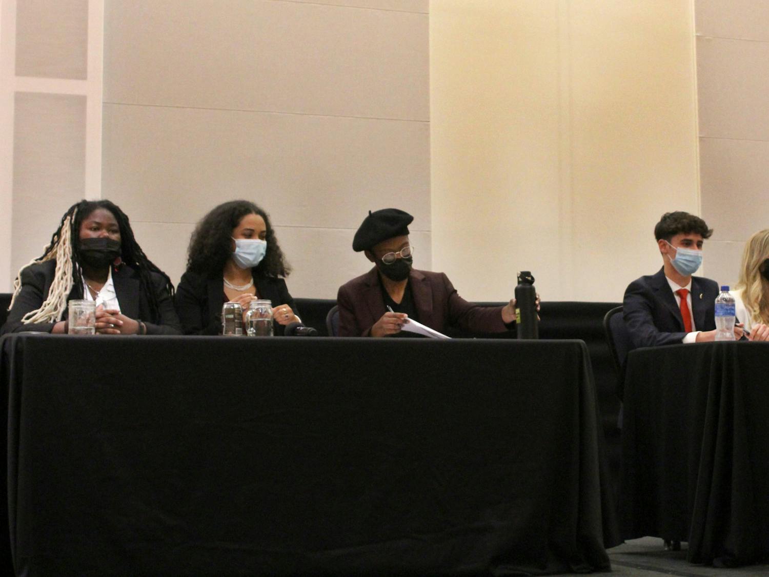 Student government executive ticket candidates for Change Party and Gator Party prepare for their opening speeches at the Reitz Union Rion Ballroom on Tuesday, Feb. 15.