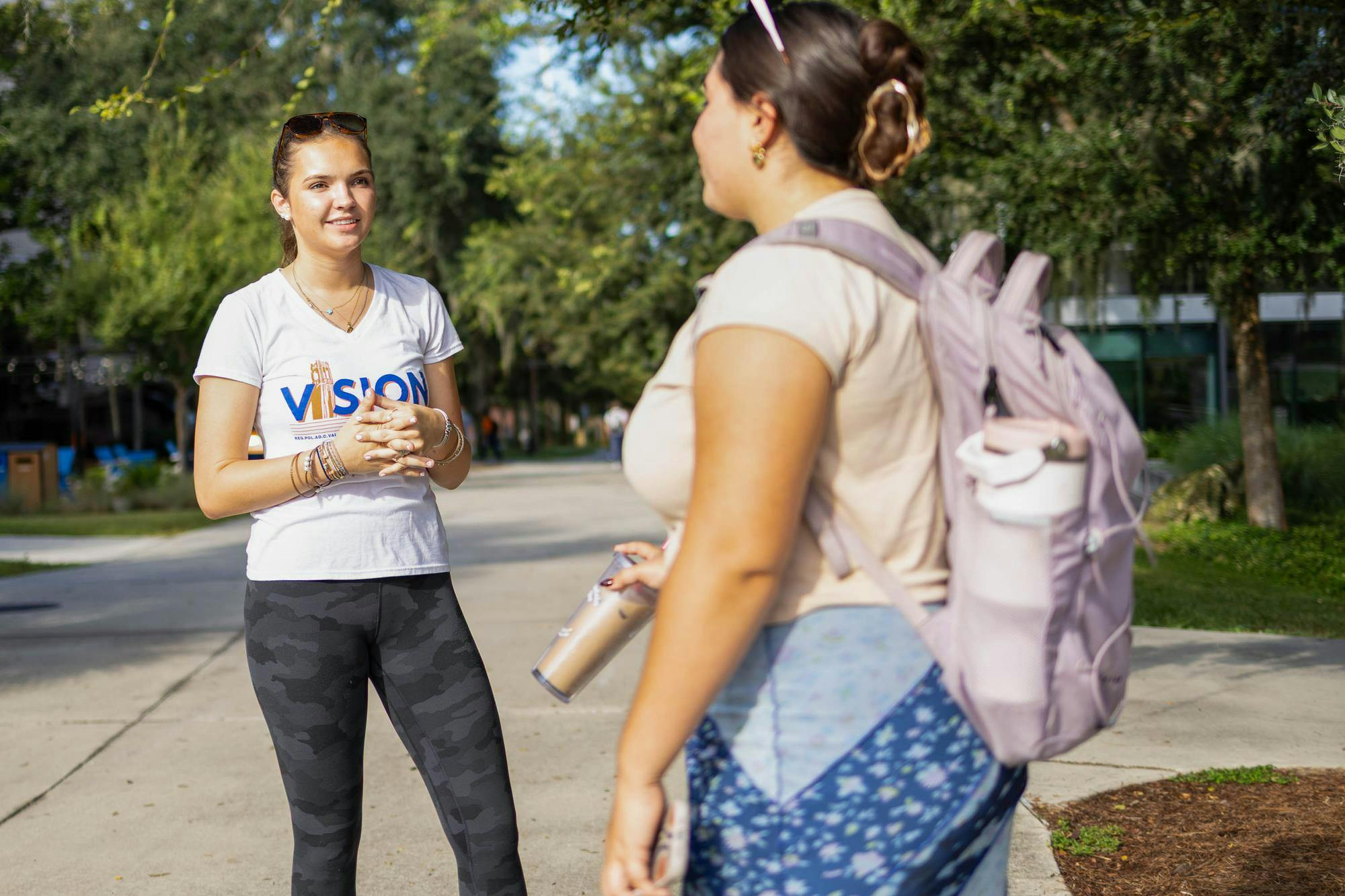 A member of Vision Party speaks to a student about the UF student government elections outside the Reitz Union, Wednesday, Sept. 30, 2026 in Gainesville, Fla.