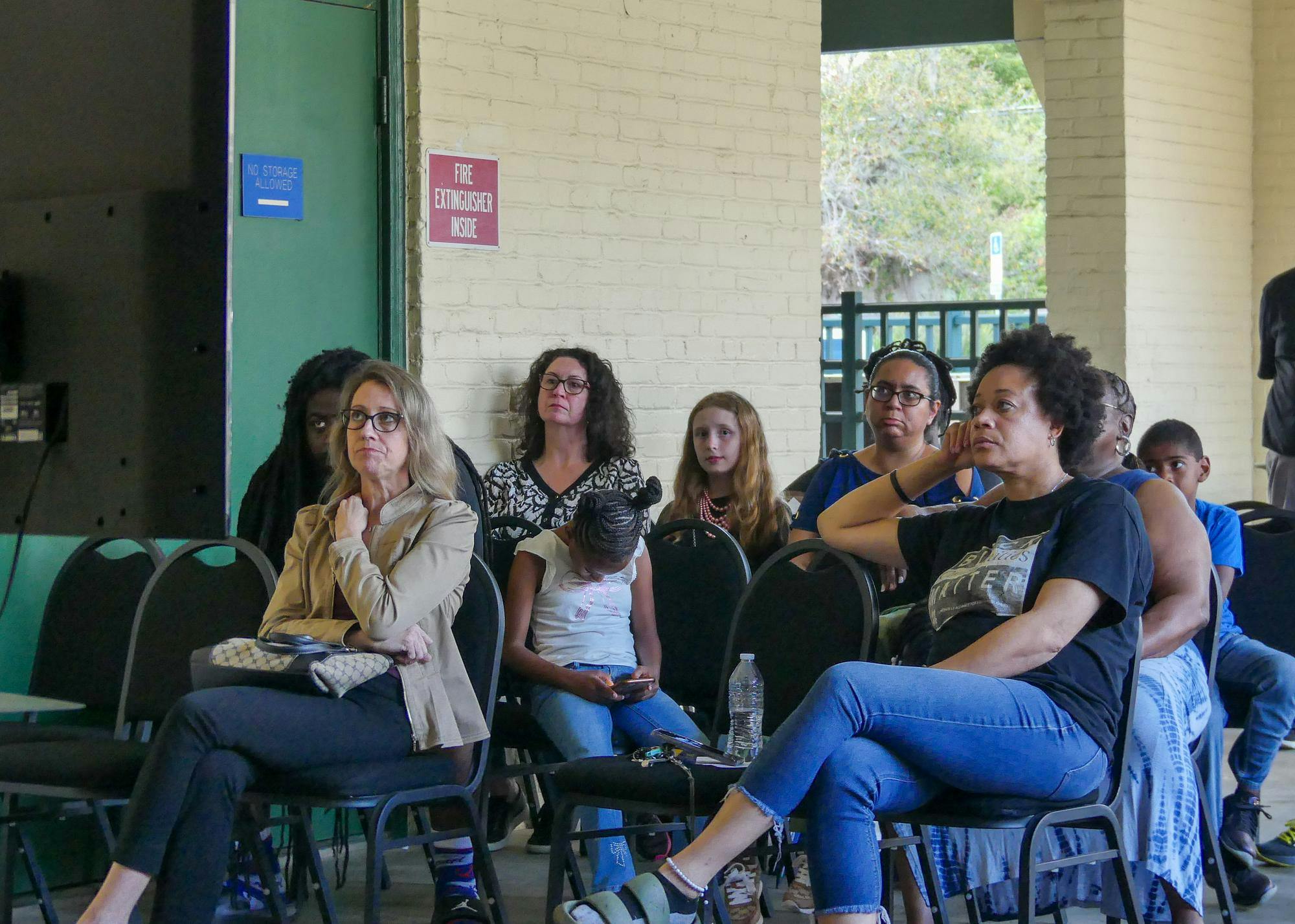Alachua County residents watch the school board meeting outside the Alachua County Public Schools District Office after the boardroom reaches full capacity, Thursday, March 12, 2026 in Gainesville, Fla. 