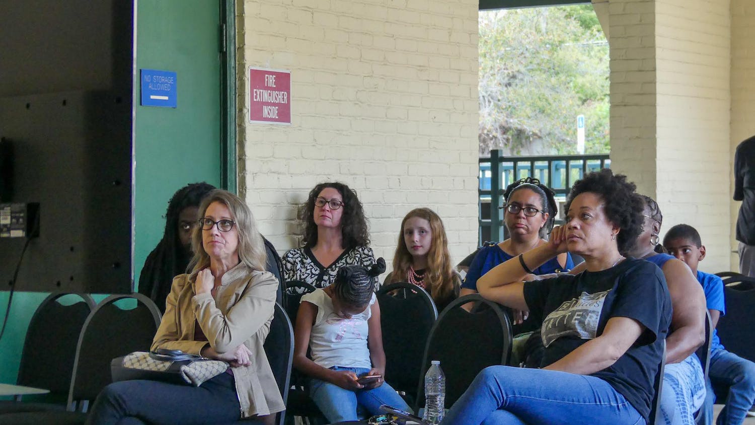 Alachua County residents watch the school board meeting outside the Alachua County Public Schools District Office after the boardroom reaches full capacity, Thursday, March 12, 2026 in Gainesville, Fla.