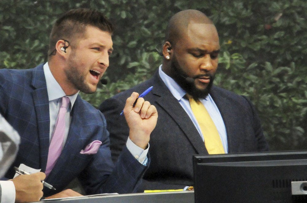 <p>Former Florida quarterback Tim Tebow (left) speaks during the SEC Nation broadcast on Sept. 26, 2015, on UF's Plaza of the Americas.</p>