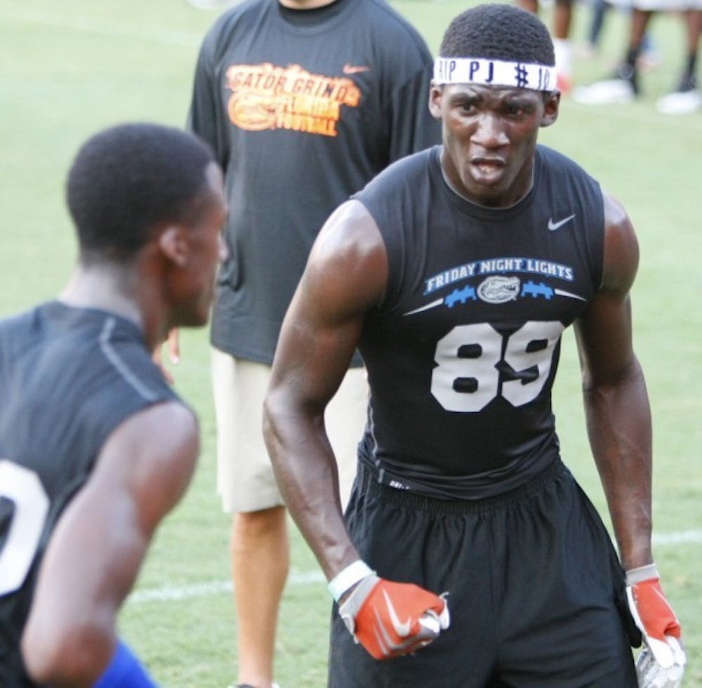 <p>High school prospect Akeem Jones participates in a drill at Friday Night Lights on July 27. Jones earned an offer from UF as an athlete.</p>