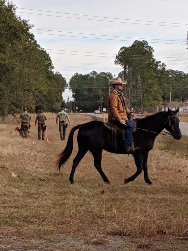 Volunteers on horseback aided officers on foot in the search through the wooded area near Grace Marketplace, at 3055 NE 28th Drive. The search lasted roughly 4 and a half hours. Courtesy to The Alligator. 