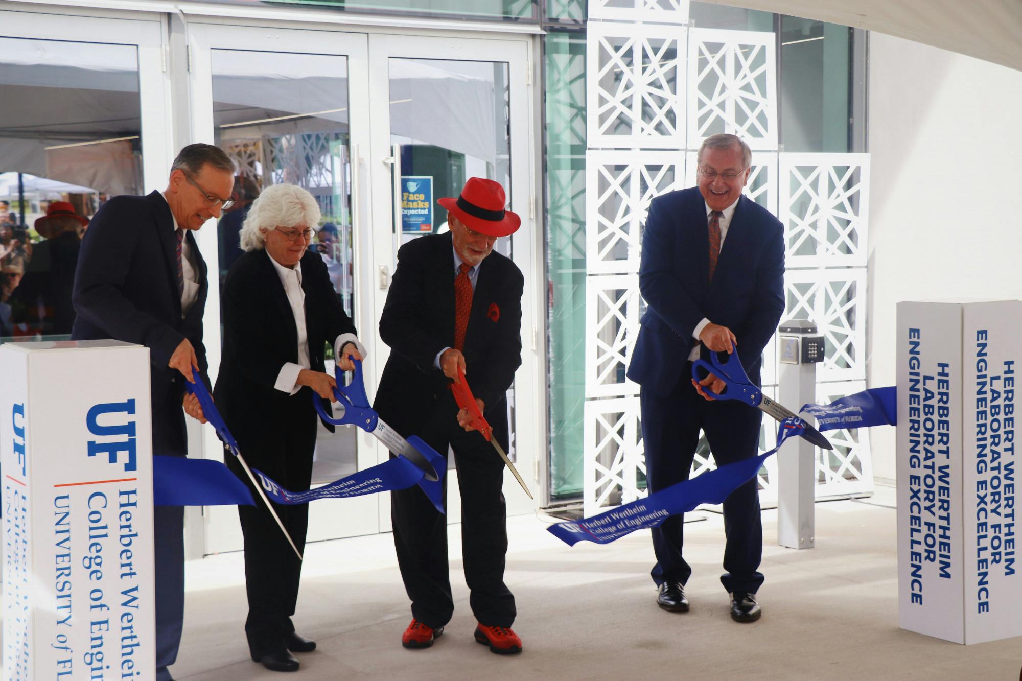 UF Provost Joseph Glover, Dean of the College of Engineering Cammy Abernathy, Herbert Wertheim and UF President Kent Fuchs (left to right) cut the ribbon at the Herbert Wertheim Laboratory for Engineering Excellence, Wertheim&#x27;s namesake, on Thursday, Oct. 7, 2021.