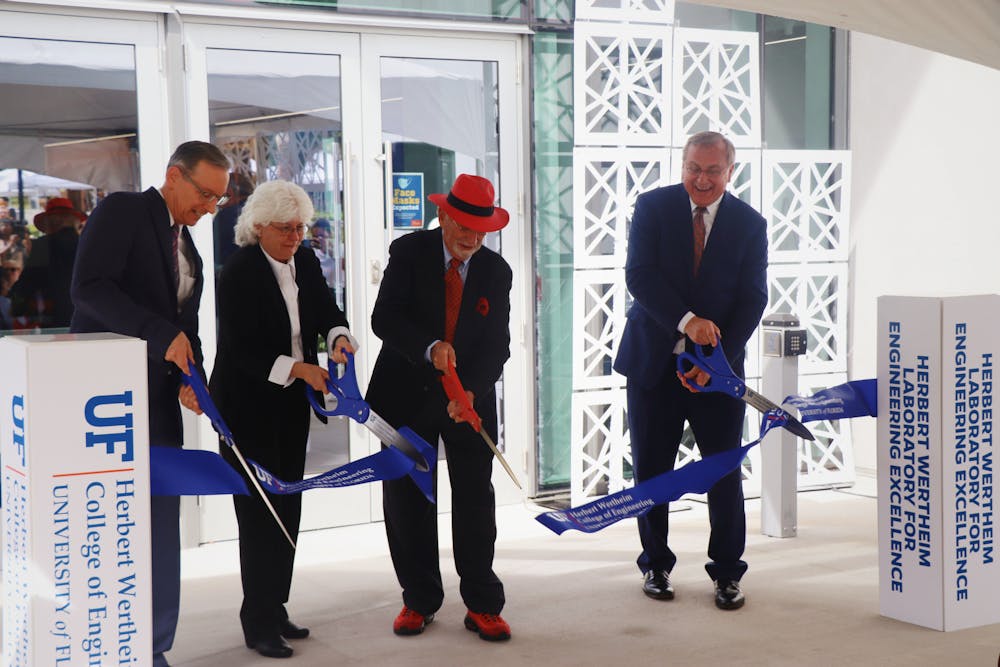 <p>UF Provost Joseph Glover, Dean of the College of Engineering Cammy Abernathy, Herbert Wertheim and UF President Kent Fuchs (left to right) cut the ribbon at the Herbert Wertheim Laboratory for Engineering Excellence, Wertheim&#x27;s namesake, on Thursday, Oct. 7, 2021.<br/></p>