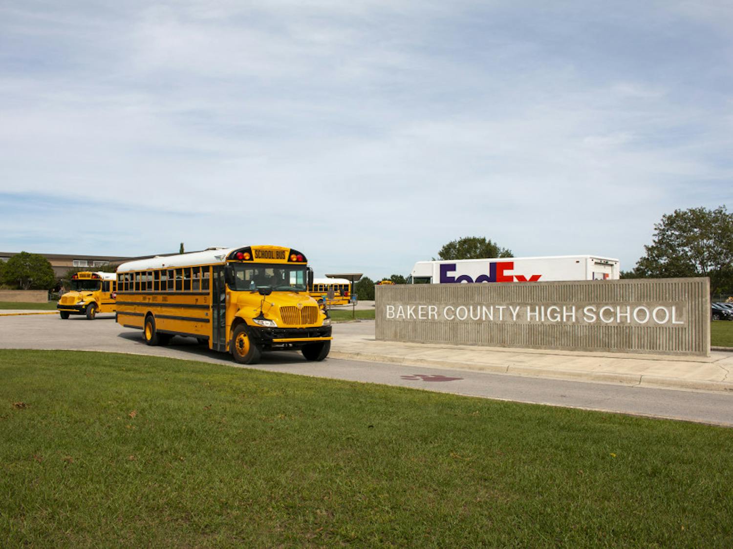 In this Oct. 17, 2019 photo, buses depart from Baker County High School in Glen St. Mary, Fla. Unease spread across Baker County when authorities arrested a 15-year-old who they say planned a massacre at the county's only high school. Anger grew when a judge dismissed second-degree felony charges against the boy.(AP Photo/Bobby Caina Calvan)
