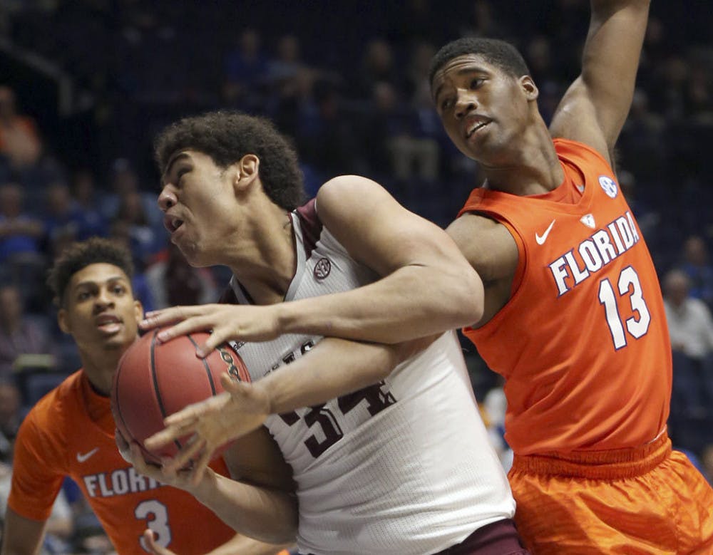 <p>Texas A&amp;M's Tyler Davis (34) gets tangled up with Florida's Kevarrius Hayes (13) during the first half of an NCAA college basketball game in the Southeastern Conference tournament in Nashville, Tenn., Friday, March 11, 2016. (AP Photo/John Bazemore)</p>