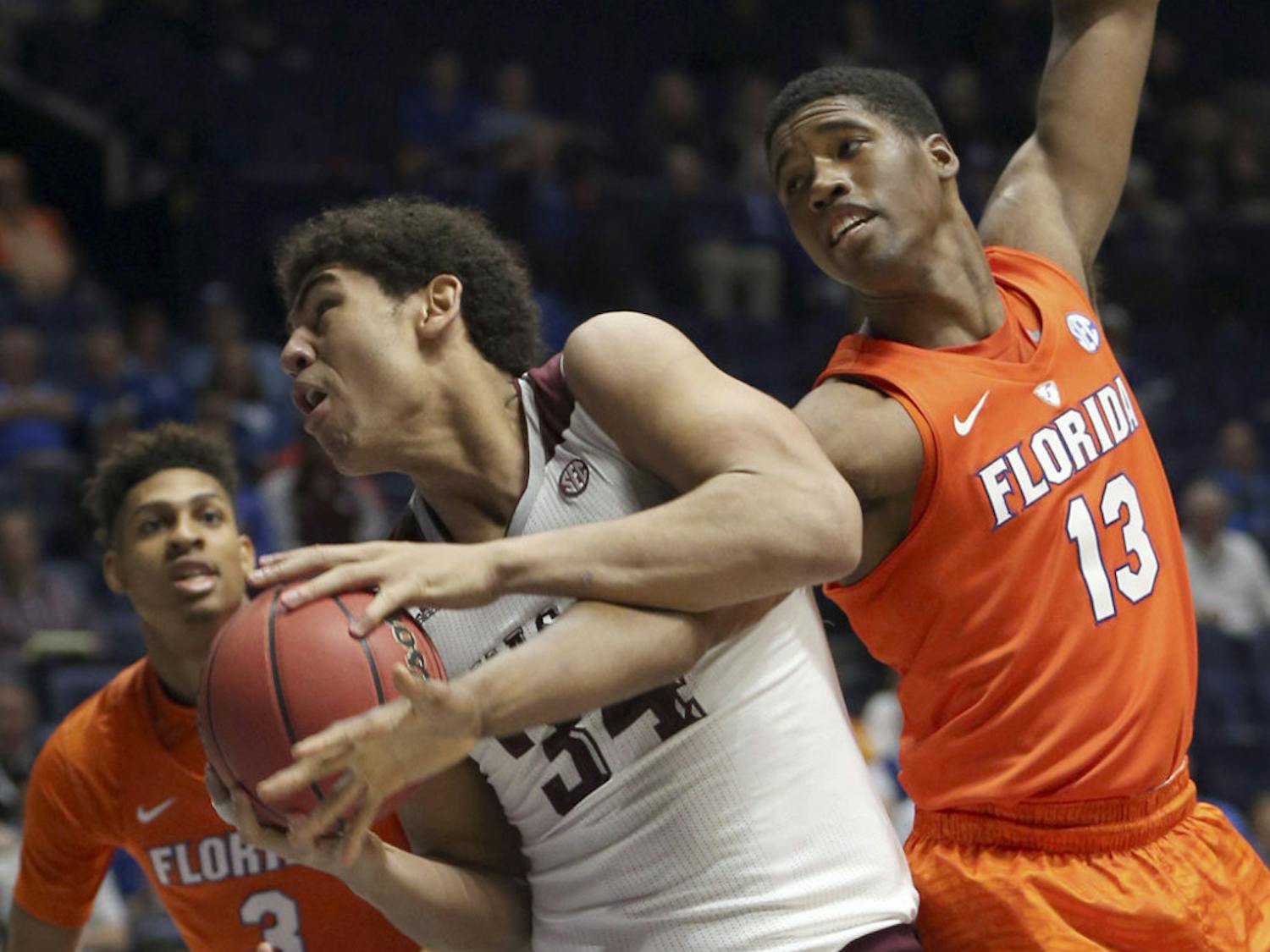 Texas A&amp;M's Tyler Davis (34) gets tangled up with Florida's Kevarrius Hayes (13) during the first half of an NCAA college basketball game in the Southeastern Conference tournament in Nashville, Tenn., Friday, March 11, 2016. (AP Photo/John Bazemore)