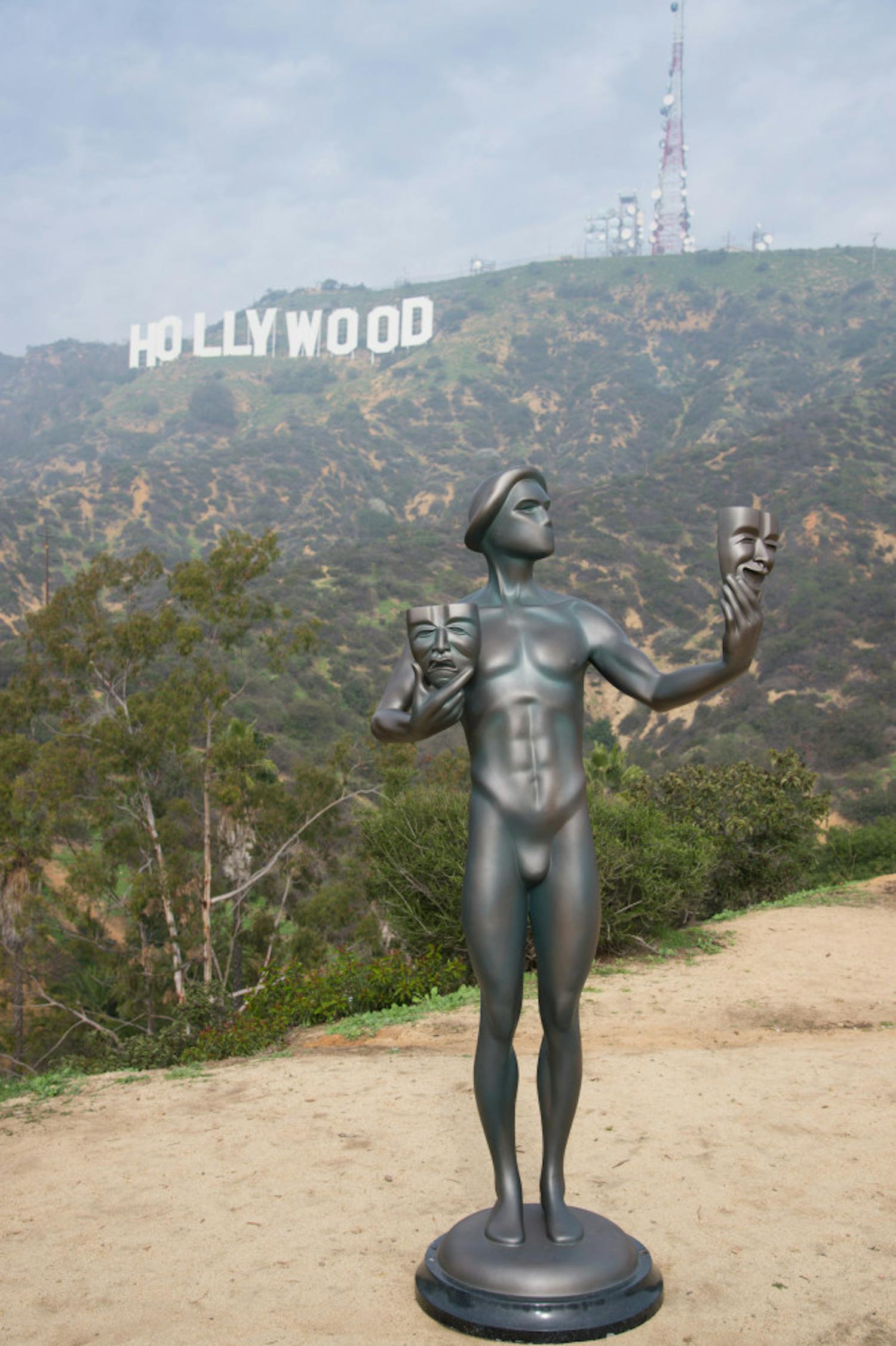 The Screen Actors Guild Awards actor statuette appears near the Hollywood Sign on Tuesday, Jan 20, 2015, in Los Angeles. The SAG awards will be presented on Jan. 25. (Photo by Rob Latour/Invision/AP)