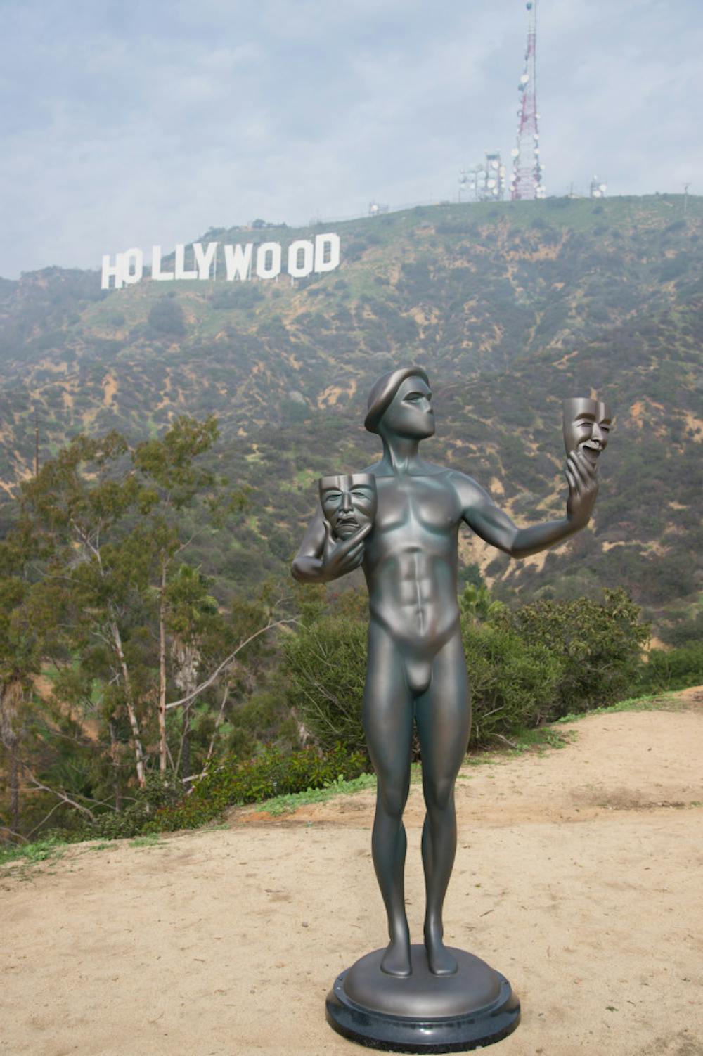 <p>The Screen Actors Guild Awards actor statuette appears near the Hollywood Sign on Tuesday, Jan 20, 2015, in Los Angeles. The SAG awards will be presented on Jan. 25. (Photo by Rob Latour/Invision/AP)</p>