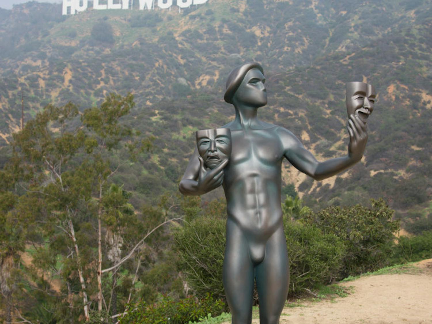 The Screen Actors Guild Awards actor statuette appears near the Hollywood Sign on Tuesday, Jan 20, 2015, in Los Angeles. The SAG awards will be presented on Jan. 25. (Photo by Rob Latour/Invision/AP)