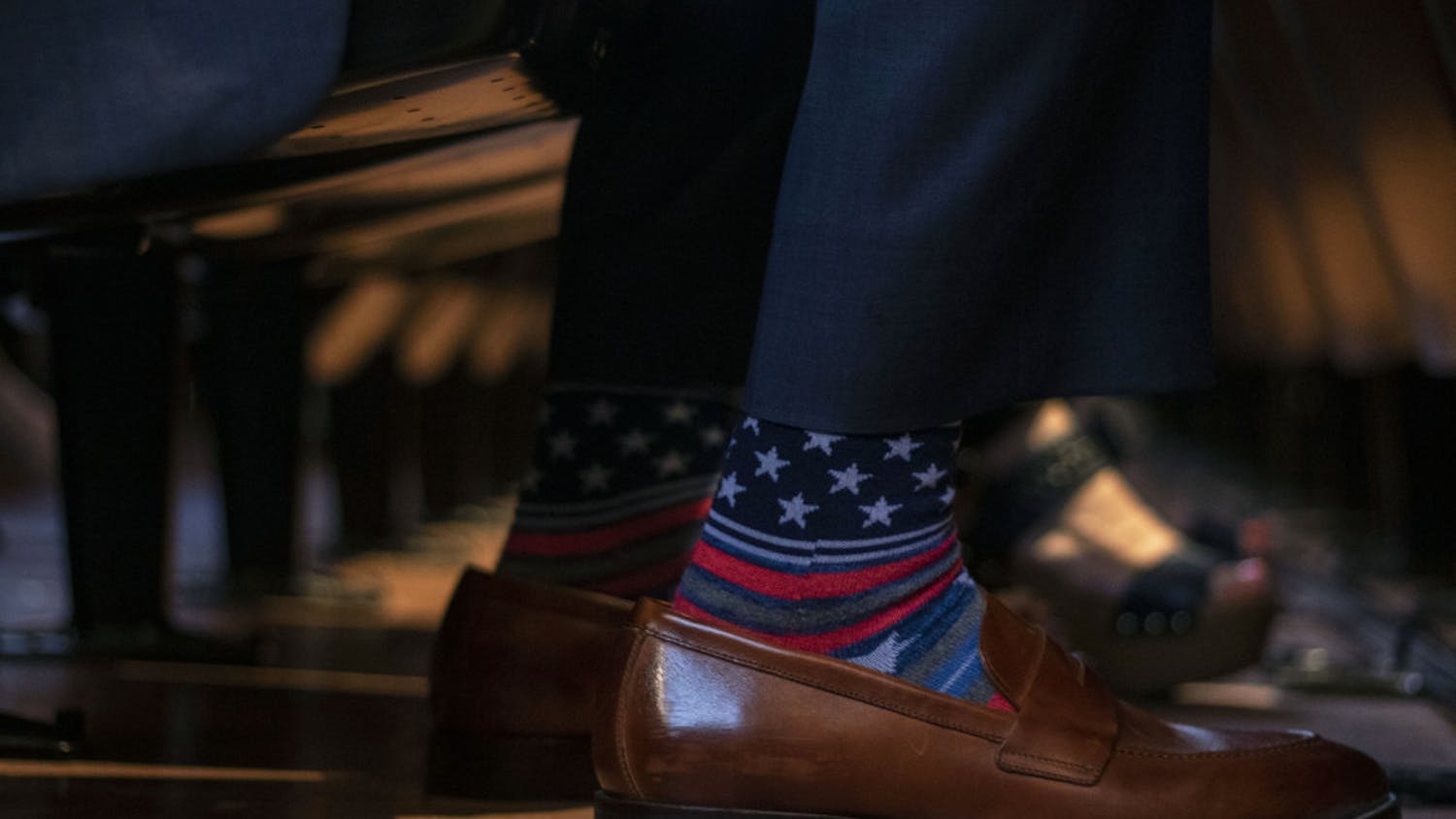 Senator Keith Perry wears socks with stars and stripes Thursday while waiting for Donald Trump Jr. to speak.