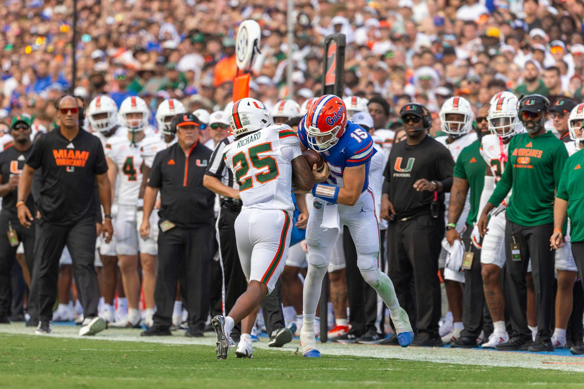 Florida Gators quarterback Graham Mertz hits Miami Hurricanes defensive back Chris Wheatley-Humphrey at the end of his run on Saturday, Aug. 31, 2024.

