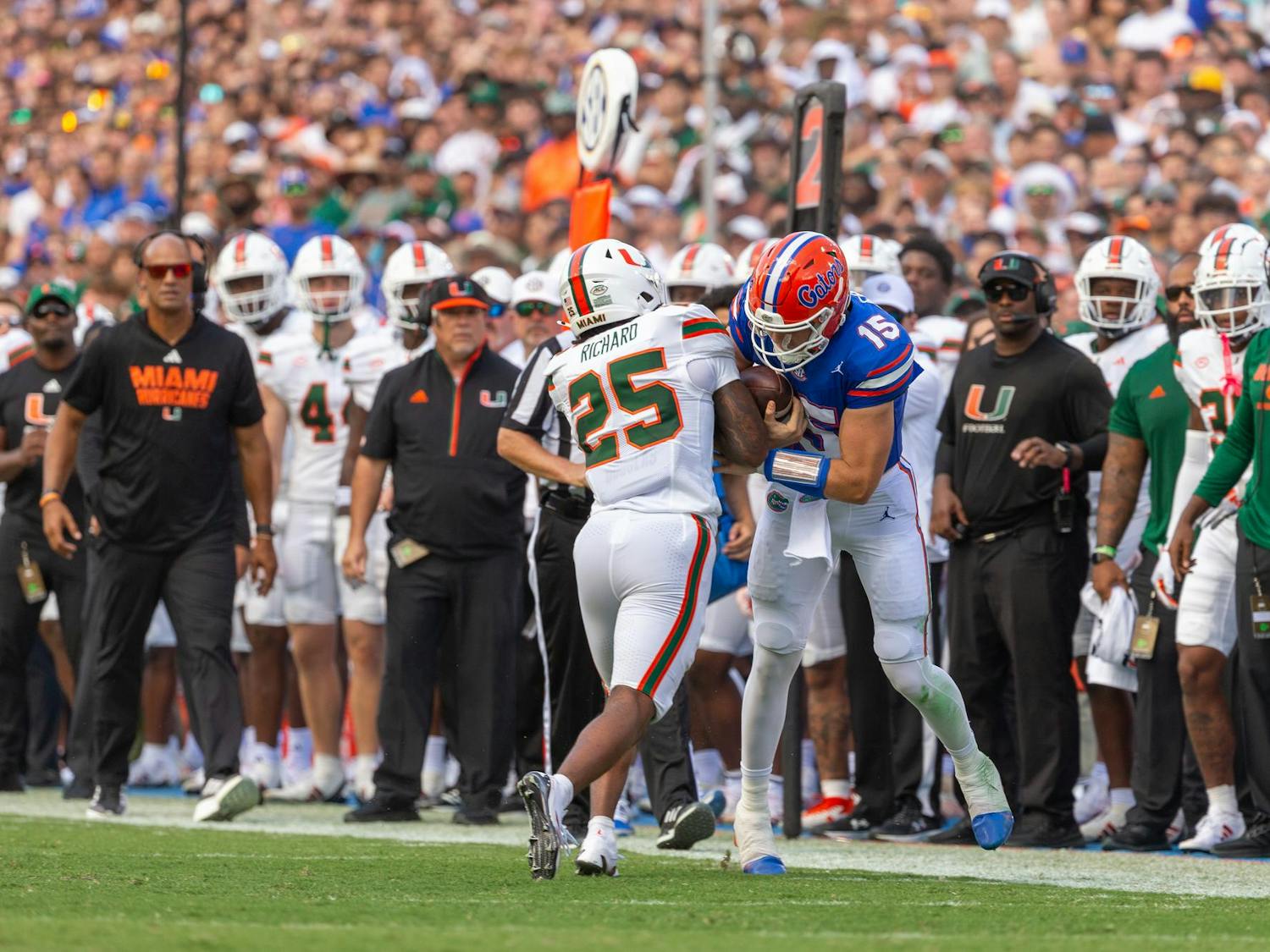 Florida Gators quarterback Graham Mertz hits Miami Hurricanes defensive back Chris Wheatley-Humphrey at the end of his run on Saturday, Aug. 31, 2024.